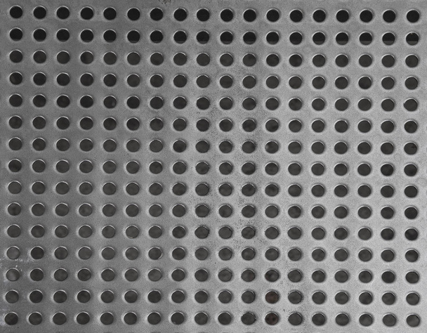 залізна решітка з нержавіючої сталі з невеликим правильним колом у формі ho
 - Фото, зображення