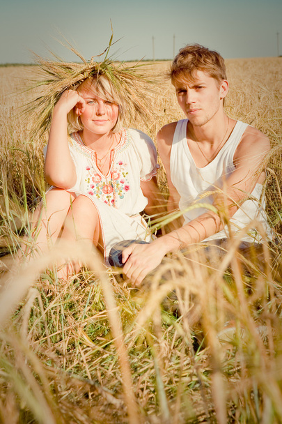 beeld van jonge man en vrouw op tarweveld - Foto, afbeelding