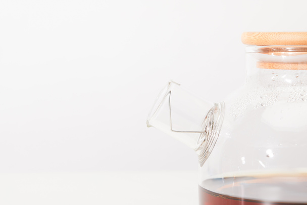 close-up view of glass kettle with fresh herbal tea on grey - Φωτογραφία, εικόνα