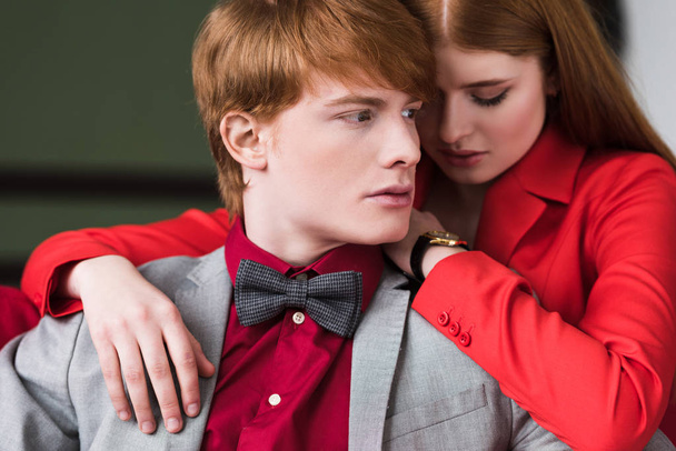 Portrait of young stylish man in bow tie and female with wristwatch - Photo, Image