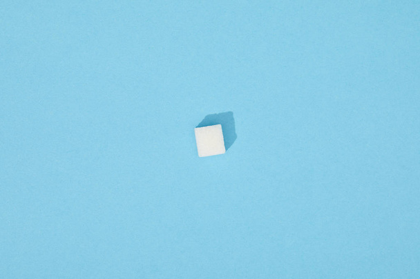 Sweet white sugar cube with shadow on blue
  - Фото, изображение