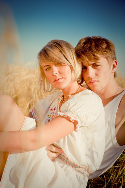 Image of young man and woman on wheat field - Foto, Bild