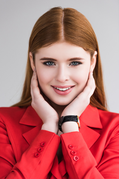 Portrait of smiling young female model with wristwatch isolated on grey - Фото, изображение