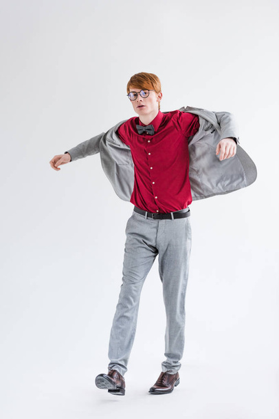 Young male model in suit isolated on grey - Фото, зображення