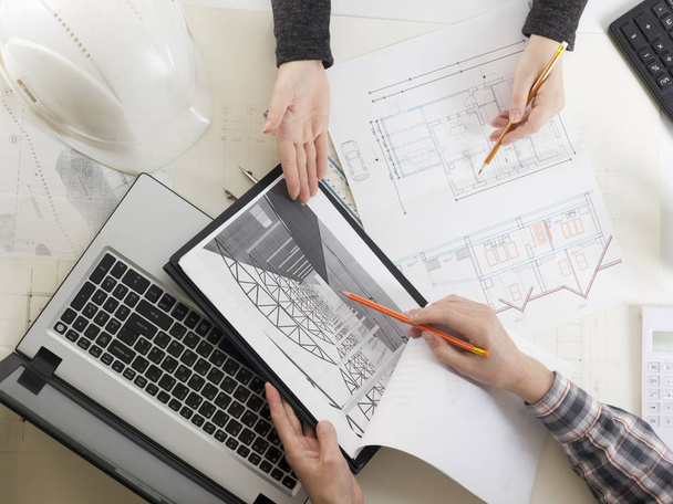 Architects working on blueprint, real estate project. Architect workplace - architectural project, blueprints, ruler, calculator, laptop and divider compass. Construction concept. Engineering tools. - Foto, imagen
