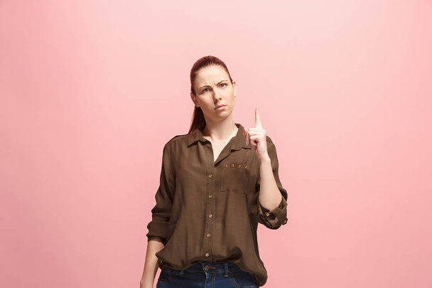The serious business woman standing and looking at camera against pink background. - Fotoğraf, Görsel