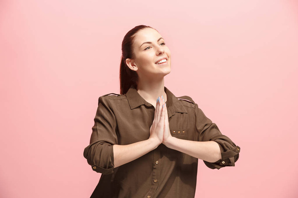 The happy business woman standing and smiling against pink background. - Foto, Bild