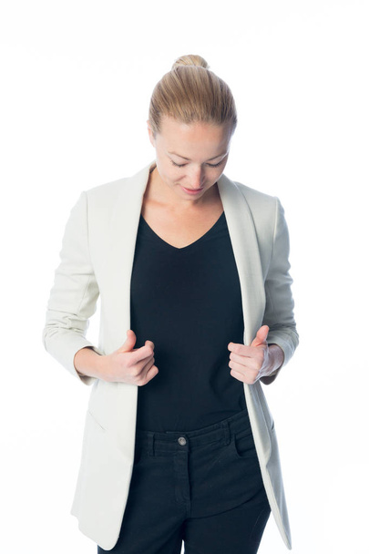 Casual, relaxed, business woman looking down, standing against white background. - Foto, Imagem