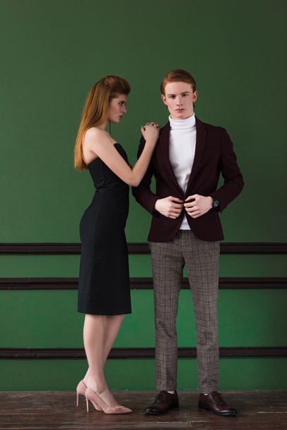 Stylish young female model in black dress with boyfriend in front of wall - Fotografie, Obrázek