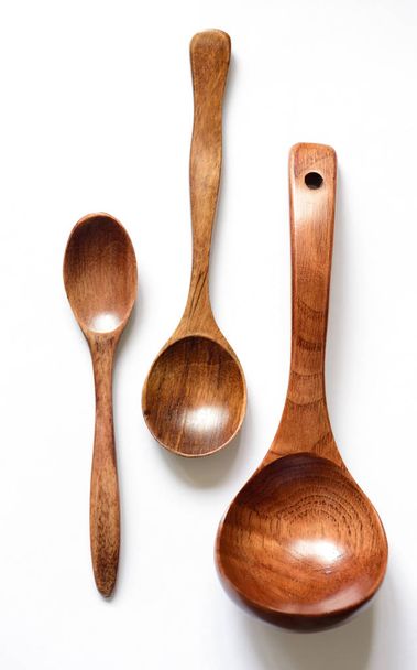 Three wooden spoon on a white background - Foto, afbeelding