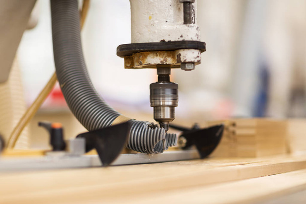 drill press machine and wooden board at workshop - Фото, изображение