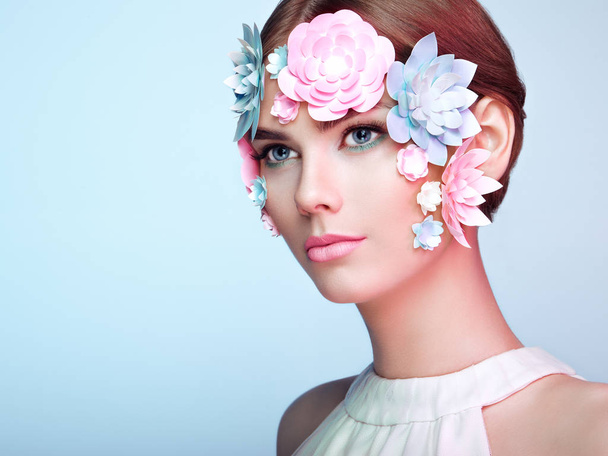 Face of beautiful woman decorated with flowers - Фото, изображение