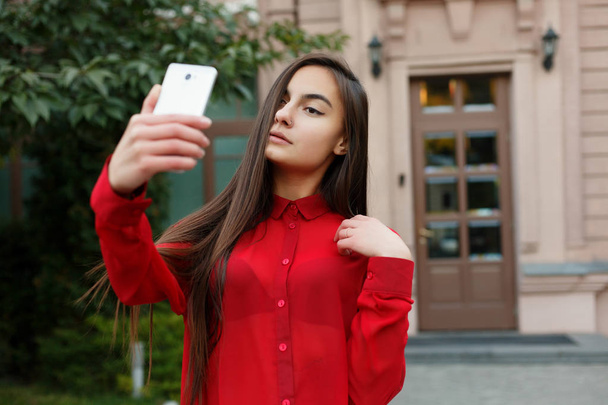 portrait of young attractive female in stylish outfit making selfie - Foto, afbeelding