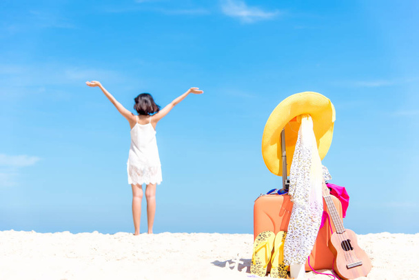 Summer traveling with ukulele and Fashion woman swimsuit Bikini, fish star, sun glasses, camera and hat on the sand beach in the holiday, blurry freedom and lifestyle woman background. - Foto, imagen