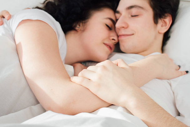 Couple in love sleeps cuddling in bed  - Foto, afbeelding