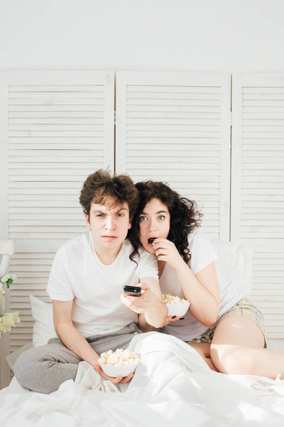 Loving couple watching TV in bed  - Photo, Image