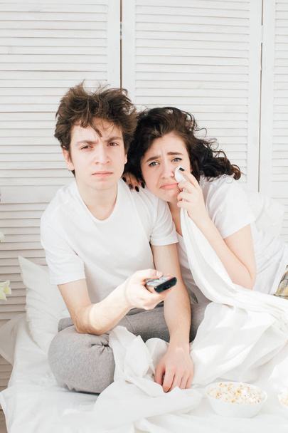 Loving couple watching TV in bed  - Valokuva, kuva