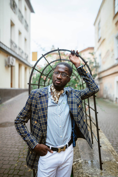 Confident young African man  in a stylish suit  on city street - Фото, изображение
