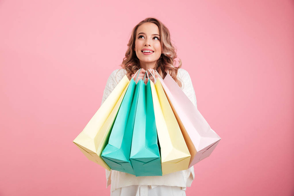 Happy young woman holding shopping bags. - Valokuva, kuva