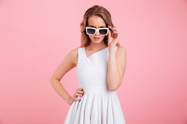 Angry young woman wearing sunglasses. Looking camera. - Foto, Imagem