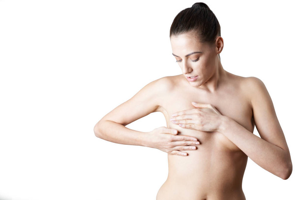 Studio Shot Of Naked Woman Woman Examining Breast - Fotografie, Obrázek
