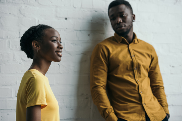 beautiful young african american couple posing in yellow shirts - Photo, Image