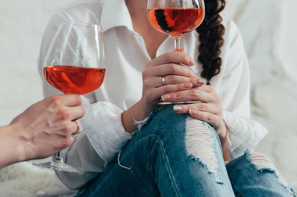 a young woman holds a glass of rose wine - Photo, Image