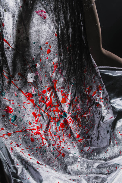 close-up of white dress with red paint at black studio background - Fotografie, Obrázek