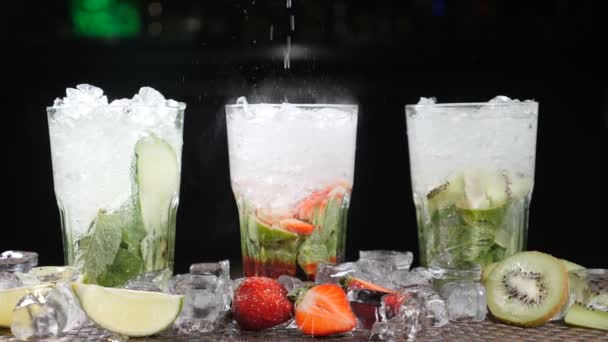 Bar and cocktail concept. Bartender prepare different Mojito Cocktails. Close up. Splashes. Slow motion. - Footage, Video