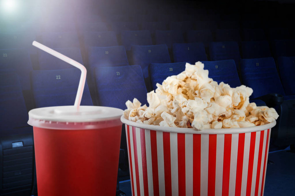Tasty popcorn and cup of drink in cinema - 写真・画像