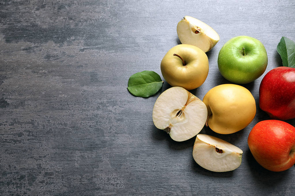 Ripe juicy apples on grey background - Fotó, kép