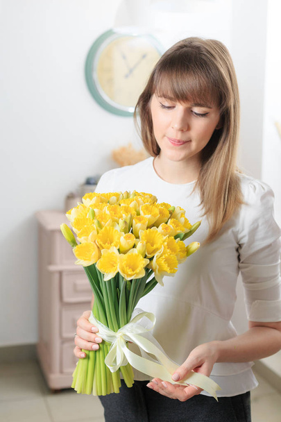 bouquet of delicate yellow color. beautiful luxury bunch of mixed flowers in womans hand. the work of the florist at a flower shop. - 写真・画像