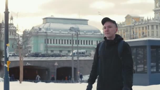 Man walking on urban street in modern city at winter day - Záběry, video