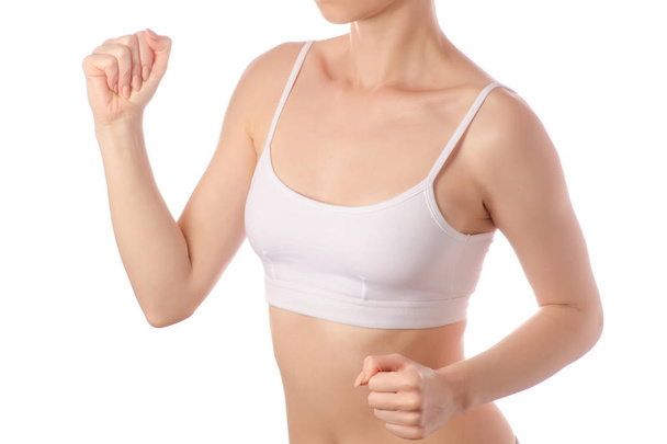 Young beautiful woman in white jersey top bra hands run jogging health sport  - 写真・画像