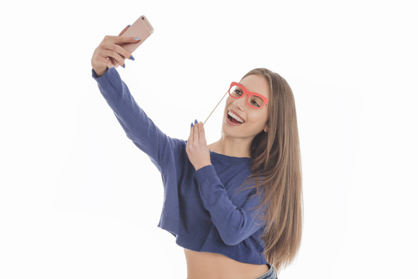 Beautiful girl taking selfie with paper glasses  - Photo, Image