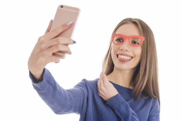 Beautiful girl taking selfie with paper glasses  - Photo, Image