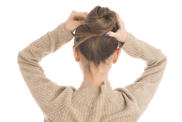 Portrait of young woman tied her hair in bun - Zdjęcie, obraz