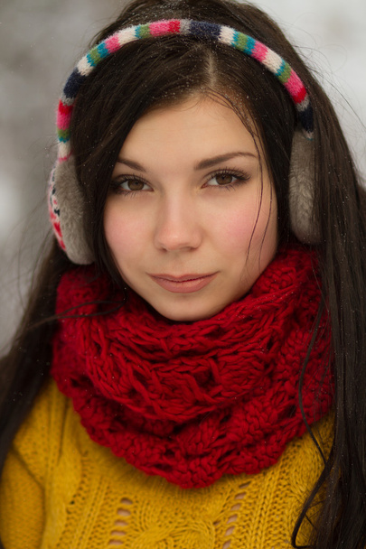 Girl in earplugs outdoors in winter - 写真・画像