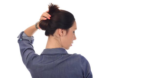 beautiful woman making hair bun. isolated on white background - Foto, Imagem
