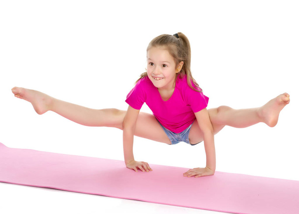 The gymnast perform an acrobatic element on the floor. - Valokuva, kuva