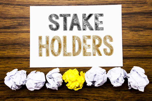 Word, writing Stake Holders. Concept for Stakeholder Engagement Written on sticky note paper reminder, wooden background with sticky, one folded paper alone for difference or collaboration - Photo, Image