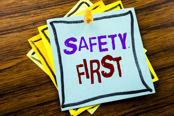 Writing text showing Safety First. Business concept for Safe Warning written on sticky note paper on the wooden background. - Foto, Imagem