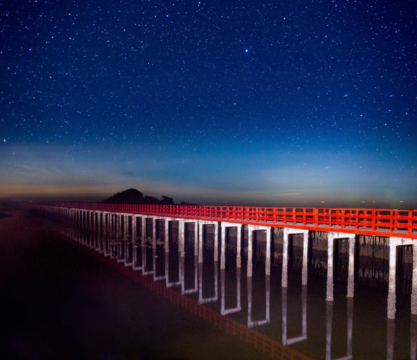 red bridge in the night sky with star on top of the sea - Photo, Image