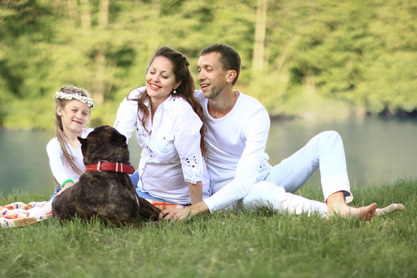 happy family with pet dog at picnic in a Sunny summer day. pregn - Fotoğraf, Görsel