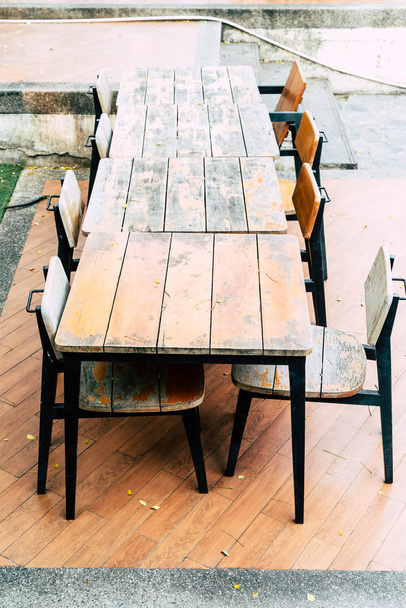 empty wood table and chair in outdoor restaurant - Fotografie, Obrázek