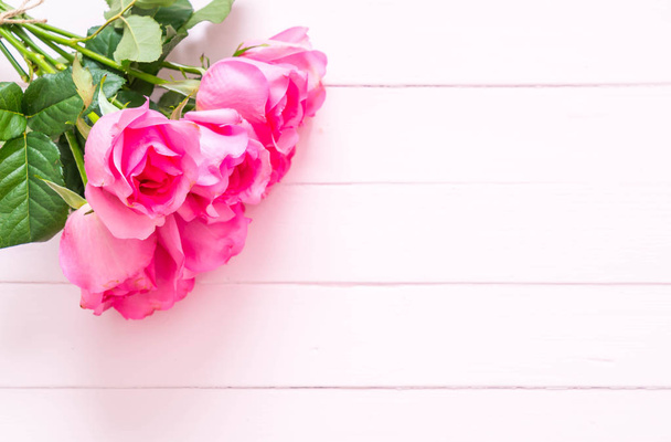 pink rose in vase on wood background - Photo, Image