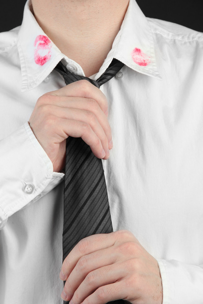 Lipstick kiss on shirt collar of man, isolated on black - Photo, image