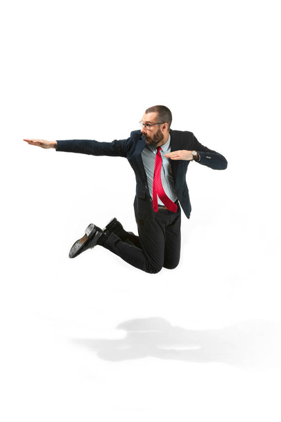 Funny cheerful businessman jumping in air over white background - Fotografie, Obrázek