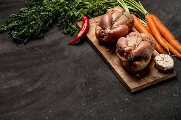 Cooking chicken with carrots, herbs and spices before baking in oven, copy space - Fotografie, Obrázek