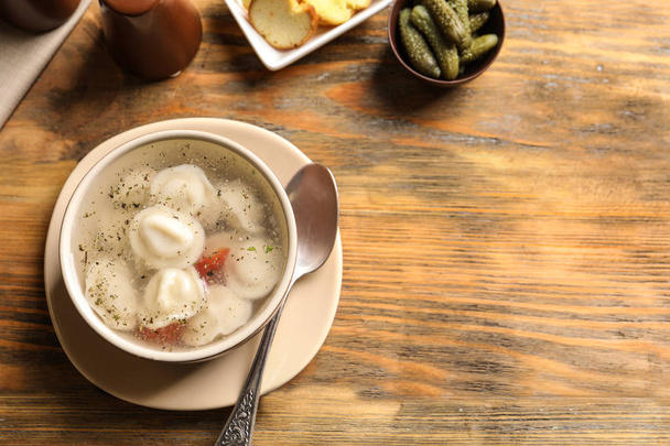 Bowl of delicious soup with dumplings on table - Photo, Image